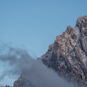 Rocks covered with snow and a mist cloud